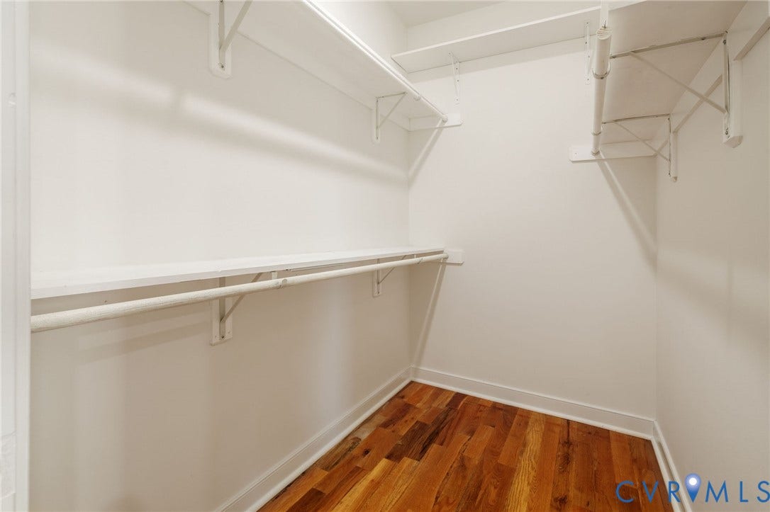 2902 Lawson Street, Richmond, VA 23224 Walk-in storage space featuring wood-finish flooring and tiered metal shelving units with integrated clothing rods