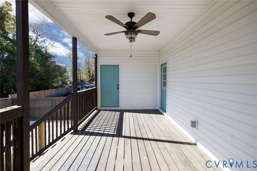 2902 Lawson Street, Richmond, VA 23224 Covered deck featuring wood-finish flooring, a ceiling fan, and two exterior doors with wood-finish railing