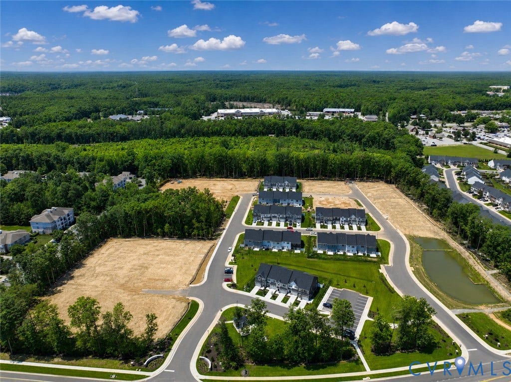 10607 Pink Lilly Lane, Chester, VA 23831 Developing residential community featuring multi-story townhomes, paved roads, and a retention pond