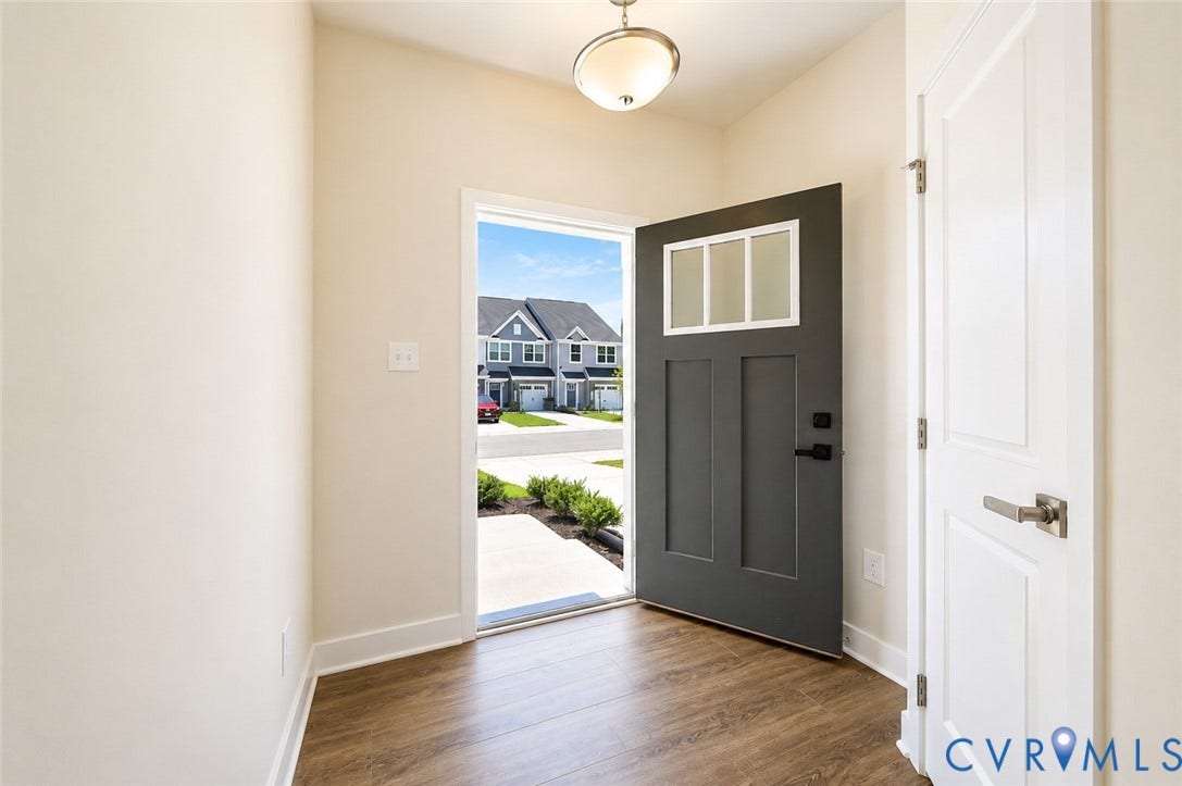 10607 Pink Lilly Lane, Chester, VA 23831 Wood-finish flooring, white trim, and a contemporary ceiling light fixture