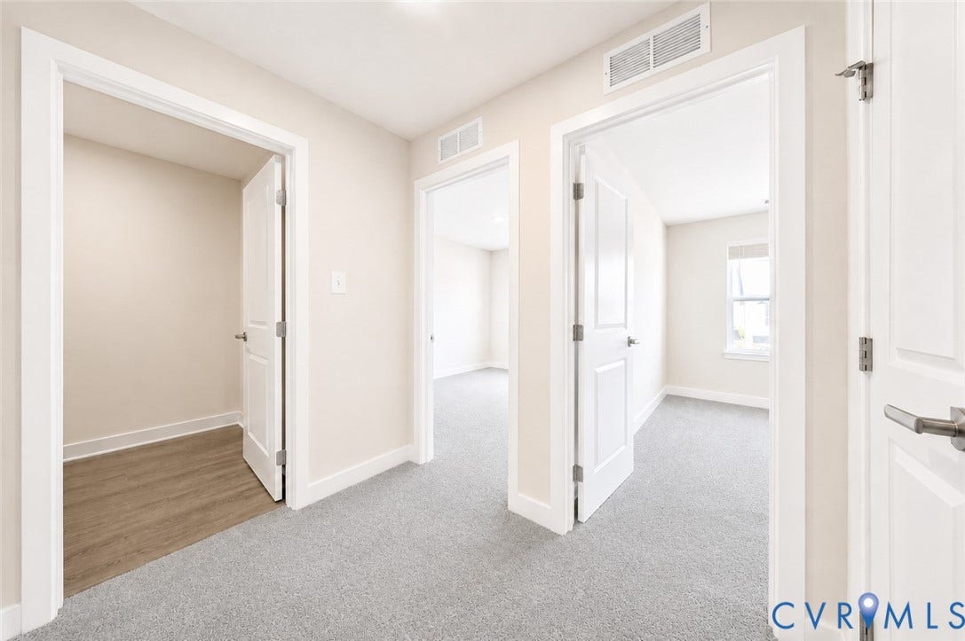 10607 Pink Lilly Lane, Chester, VA 23831 Hallway with light gray carpeting, white painted walls, and white trim