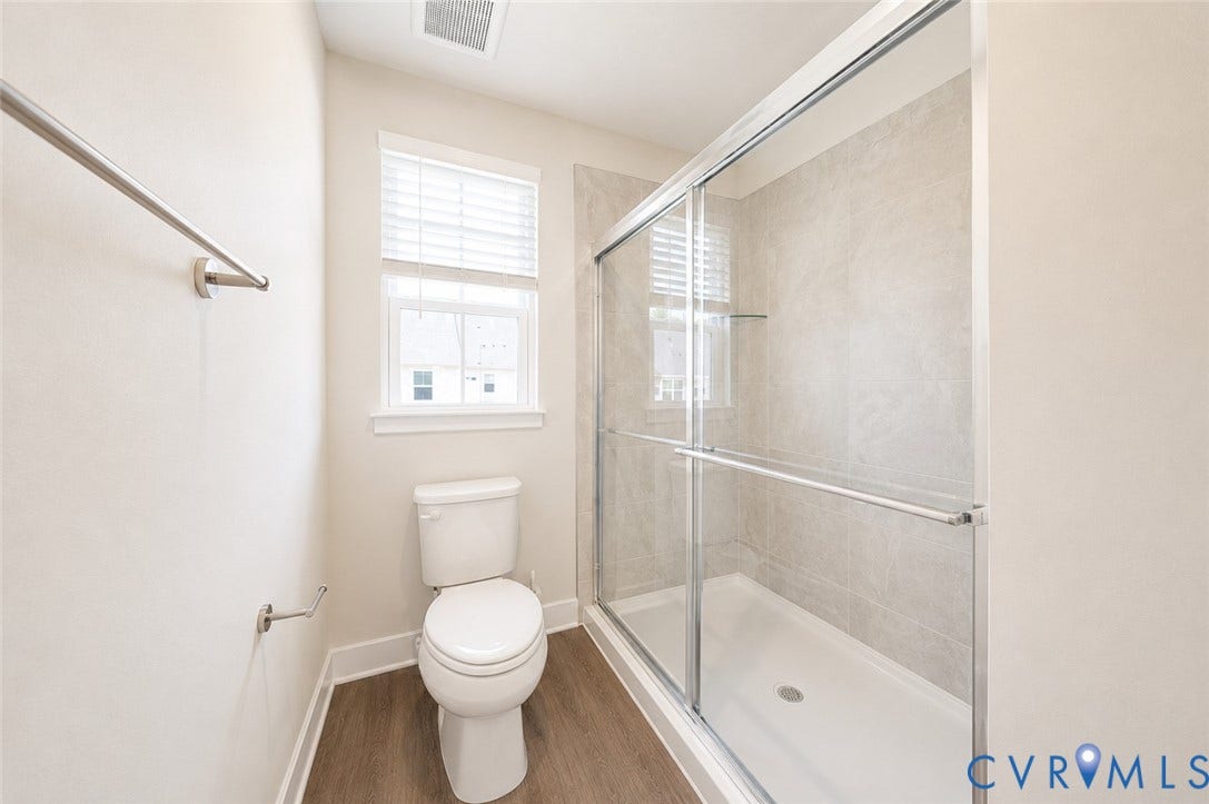 10607 Pink Lilly Lane, Chester, VA 23831 Walk-in shower with clear glass enclosure and light-toned tile surround