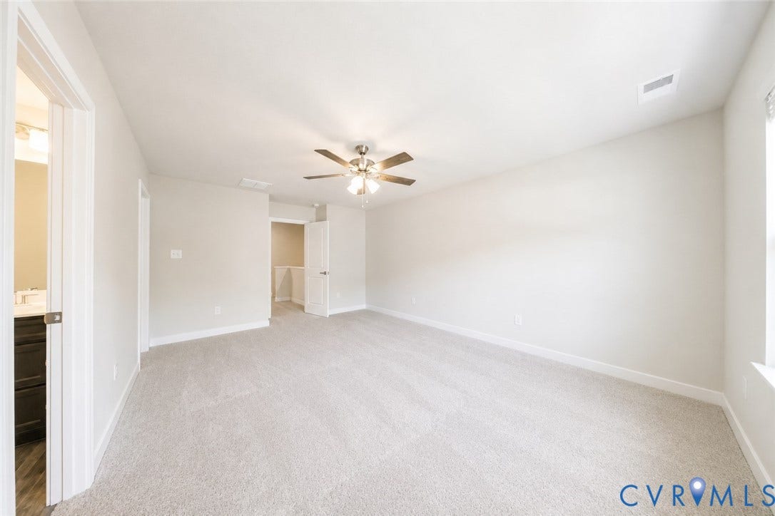 10607 Pink Lilly Lane, Chester, VA 23831 Spacious room featuring light-colored carpeting, a ceiling fan with integrated lighting, and neutral wall paint