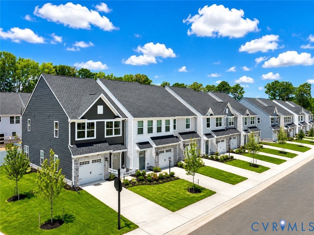 10607 Pink Lilly Lane, Chester, VA 23831 Contemporary townhome with a dark gray and white facade, featuring a private garage and manicured lawn