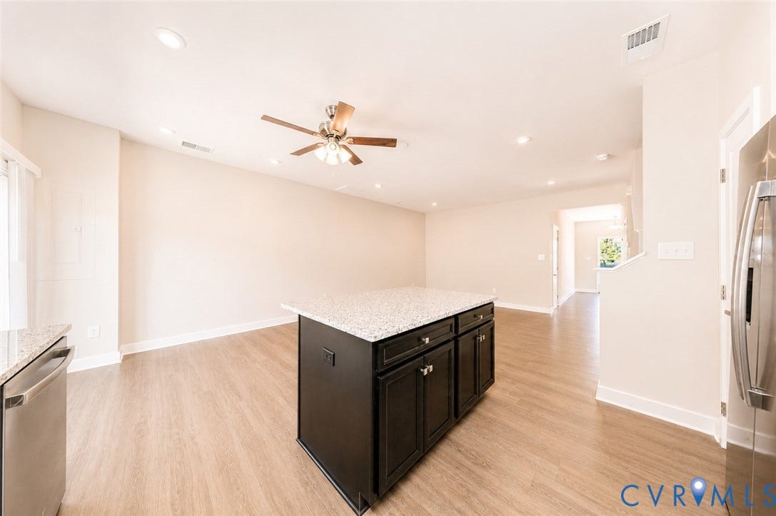 10607 Pink Lilly Lane, Chester, VA 23831 Central island with a light-toned countertop, wood-finish flooring, recessed lighting, ceiling fan, and stainless steel appliances