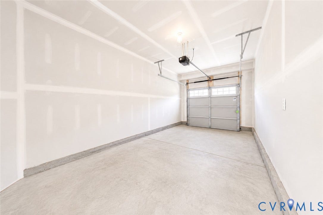 10607 Pink Lilly Lane, Chester, VA 23831 Attached garage with concrete flooring, automatic garage door opener, and integrated window panels