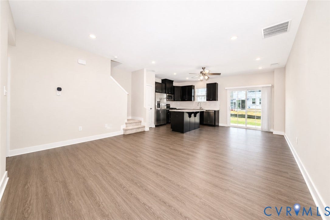 10607 Pink Lilly Lane, Chester, VA 23831 Wood-finish flooring throughout, recessed lighting, and a kitchen featuring dark cabinetry with stainless steel appliances