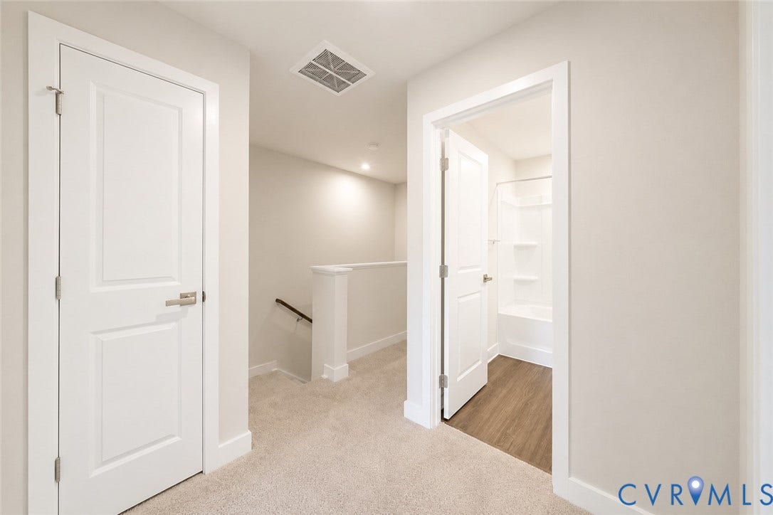 10607 Pink Lilly Lane, Chester, VA 23831 Carpeted hallway with painted walls, recessed lighting, and a partial staircase with a wood handrail
