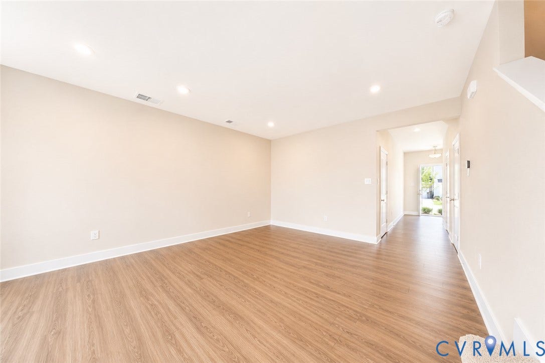 10607 Pink Lilly Lane, Chester, VA 23831 Open-concept living space with wood-finish flooring, recessed lighting, and a neutral color palette