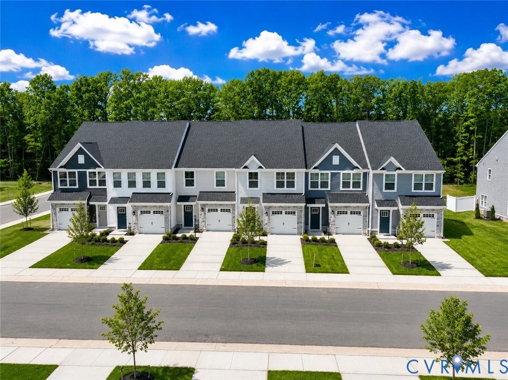 10607 Pink Lilly Lane, Chester, VA 23831 Modern townhome exteriors featuring multiple gables, white garage doors, and front entryways with dark doors