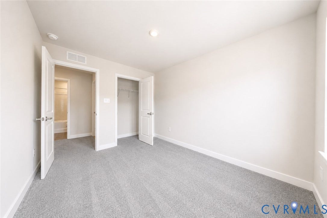 10607 Pink Lilly Lane, Chester, VA 23831 Light gray carpeting, a built-in closet with shelving, and a bright window