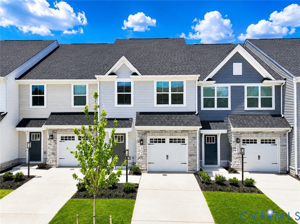 10607 Pink Lilly Lane, Chester, VA 23831 Modern townhome exterior featuring light gray siding, stone veneer accents, individual attached garages, and prominent entryways