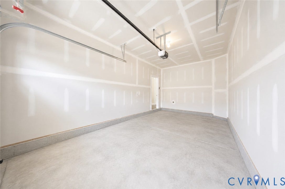 10607 Pink Lilly Lane, Chester, VA 23831 Concrete flooring with a finished concrete perimeter, exposed ceiling joists, and a garage door opener