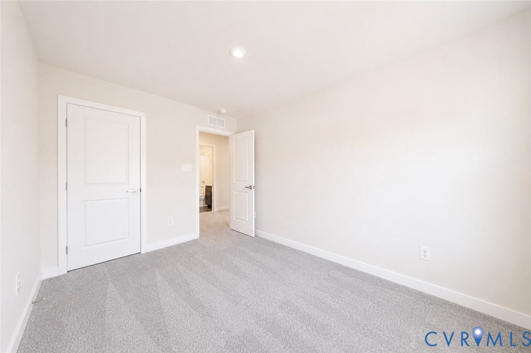 10607 Pink Lilly Lane, Chester, VA 23831 Neutral wall color, plush carpeting, recessed lighting, and white paneled doors
