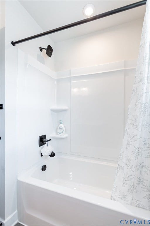 1943 Enon Station Drive, Chester, VA 23836 Bathtub with a shower head, matte black fixtures, and recessed lighting