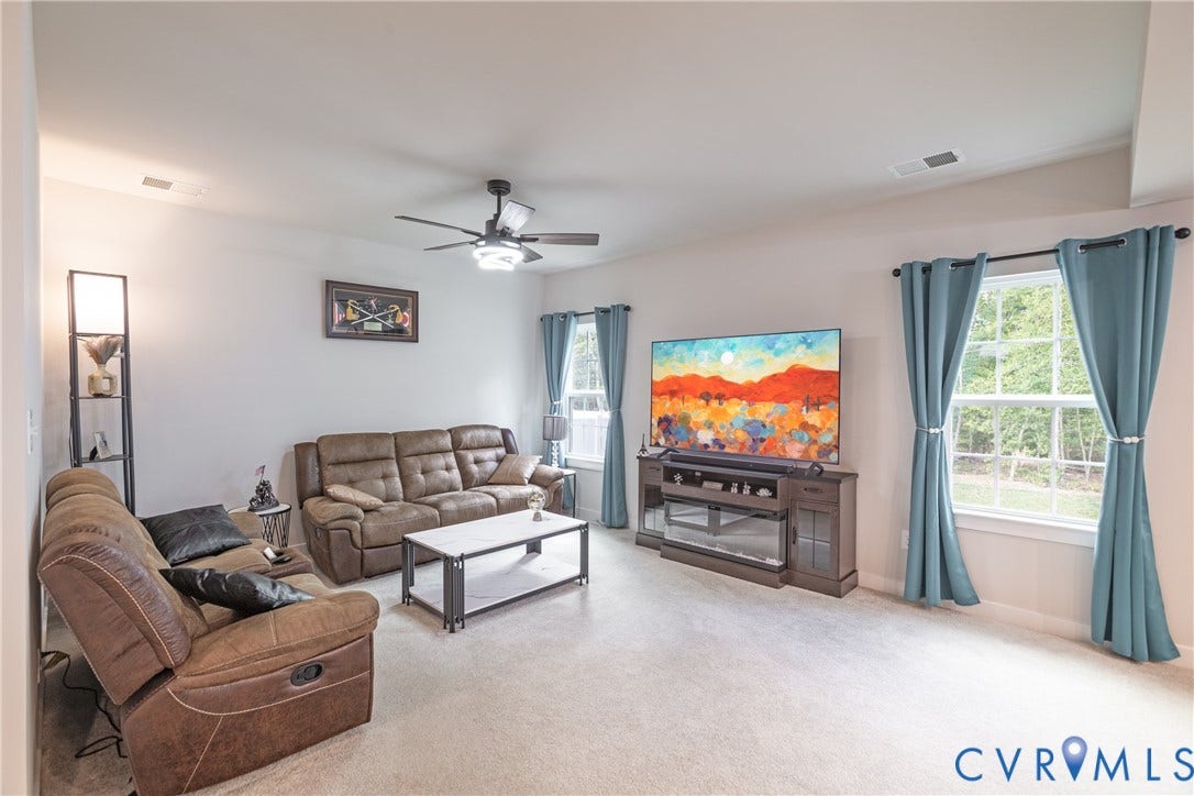 1943 Enon Station Drive, Chester, VA 23836 Neutral wall finishes, recessed lighting, ceiling fan with integrated light, multiple large windows, and wall-to-wall carpeting