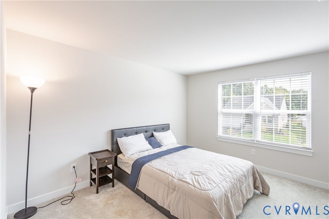 1943 Enon Station Drive, Chester, VA 23836 Plush carpet flooring, neutral wall tones, window with horizontal blinds, and a permanent floor outlet