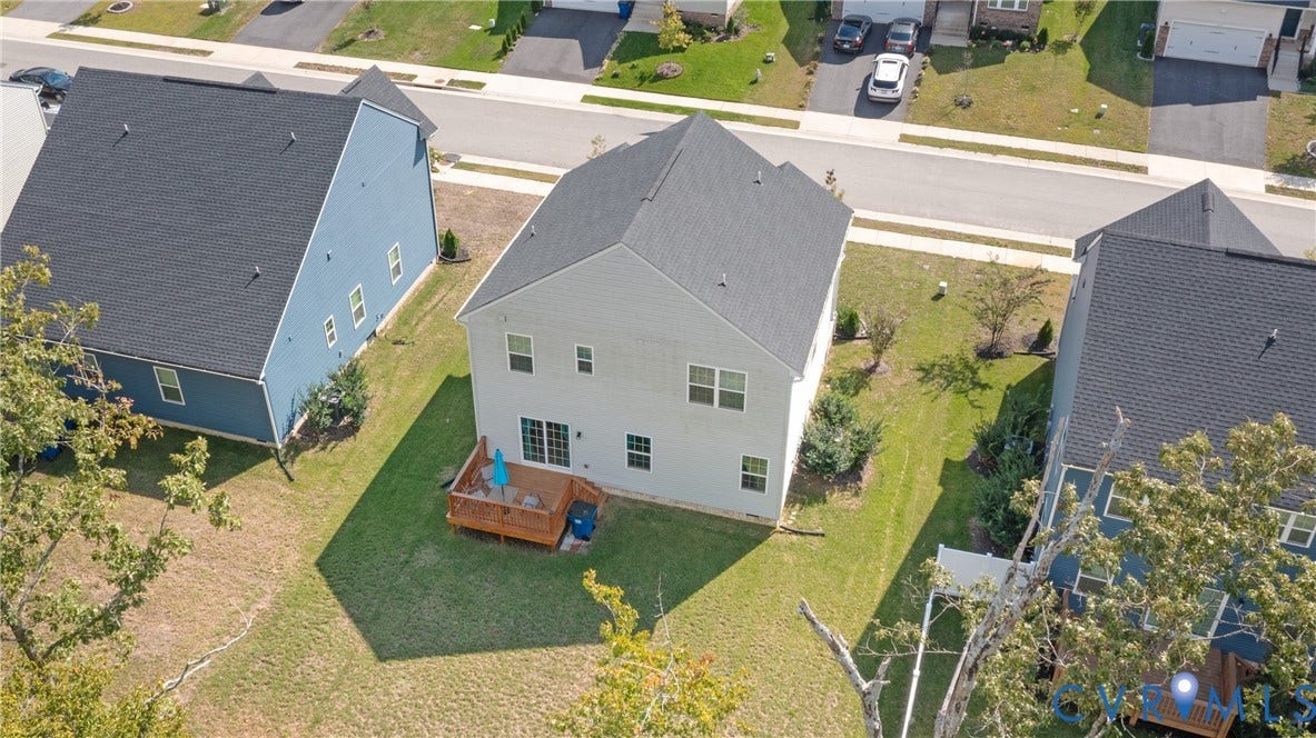 1943 Enon Station Drive, Chester, VA 23836 Two-story property with light-colored siding, a dark shingle roof, and a wood deck at the rear