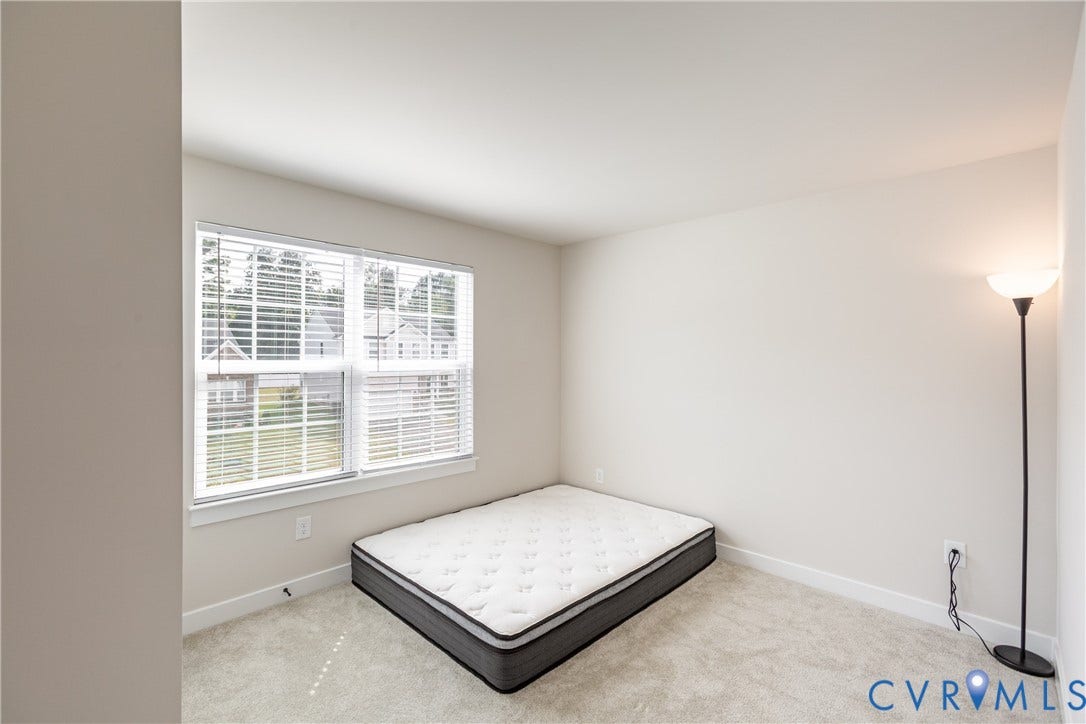 1943 Enon Station Drive, Chester, VA 23836 Carpeted room with a double window featuring blinds, and neutral wall tones