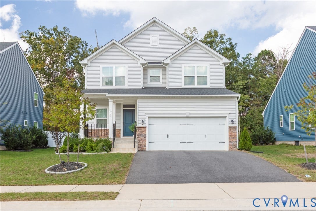 1943 Enon Station Drive, Chester, VA 23836 Modern two-story residence with light gray siding, an attached two-car garage, and a covered entryway
