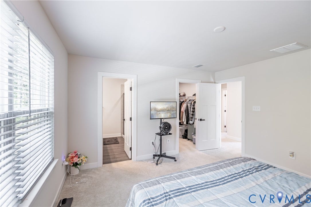 1943 Enon Station Drive, Chester, VA 23836 Plush carpeted flooring, white interior doors with dark hardware, recessed ceiling lighting, and a window with horizontal blinds