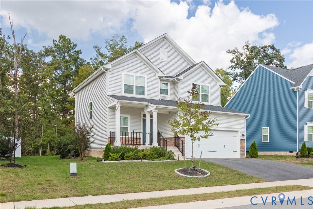 1943 Enon Station Drive, Chester, VA 23836 Two-story residence featuring light gray siding, an attached garage, and a covered porch with white columns