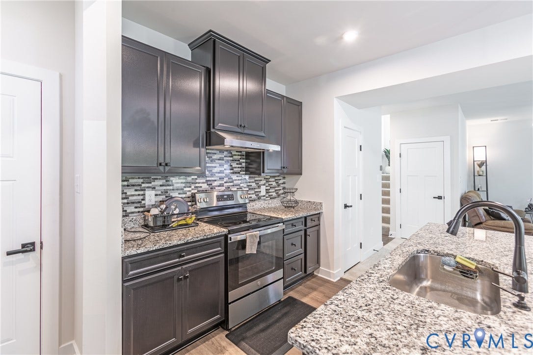 1943 Enon Station Drive, Chester, VA 23836 Kitchen featuring granite countertops, stainless steel appliances, dark cabinetry, and a tile backsplash