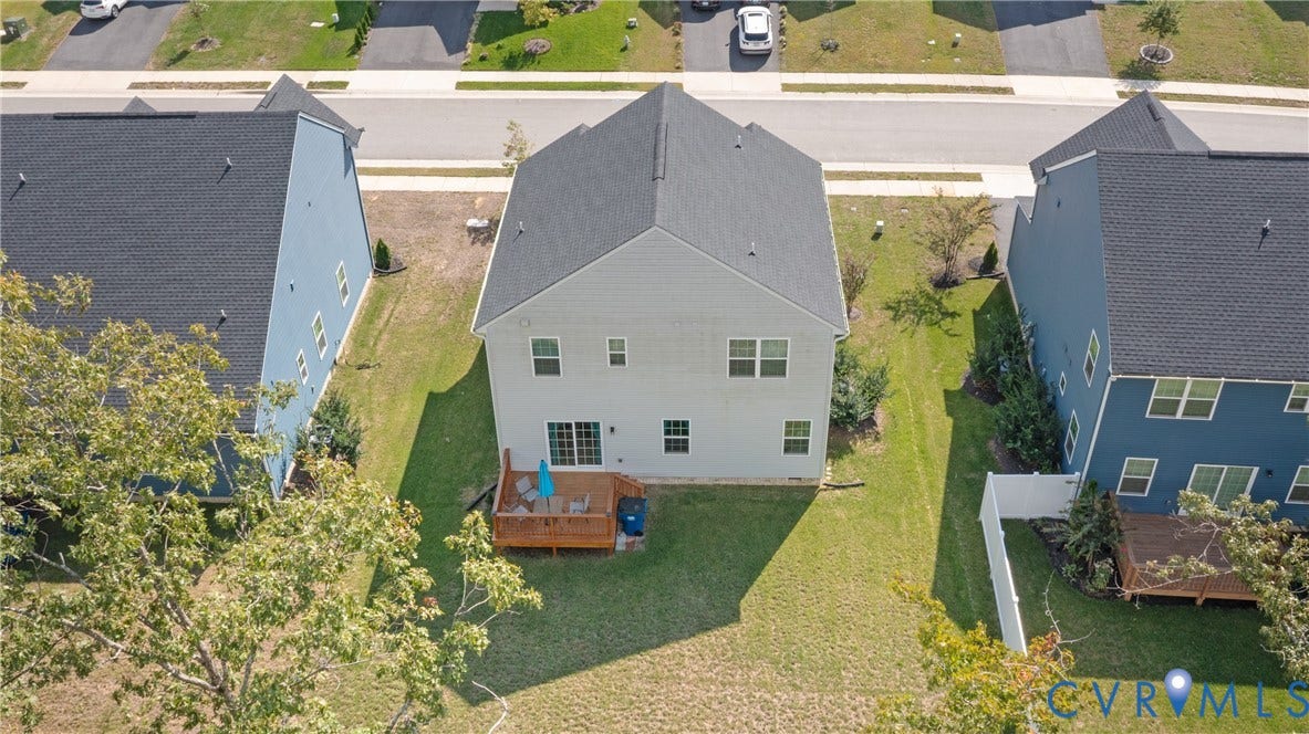 1943 Enon Station Drive, Chester, VA 23836 Two-story residential structure with a dark shingle roof, light-colored siding, and a wooden deck