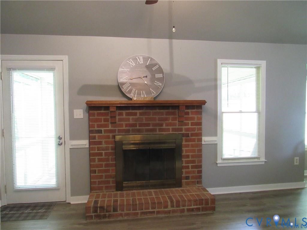 8506 Lyndale Drive, Chesterfield, VA 23235 Brick fireplace with a wood mantel, brass firebox, and a brick hearth