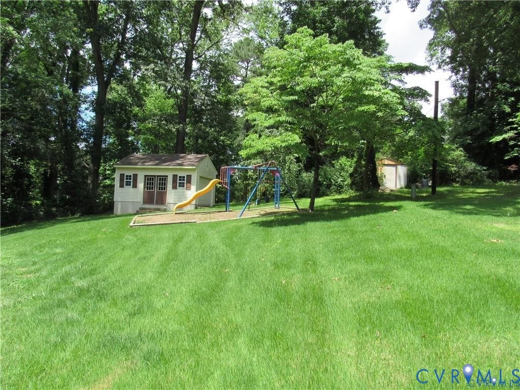 8506 Lyndale Drive, Chesterfield, VA 23235 Expansive yard featuring a detached storage shed, mature trees, and lush green lawn