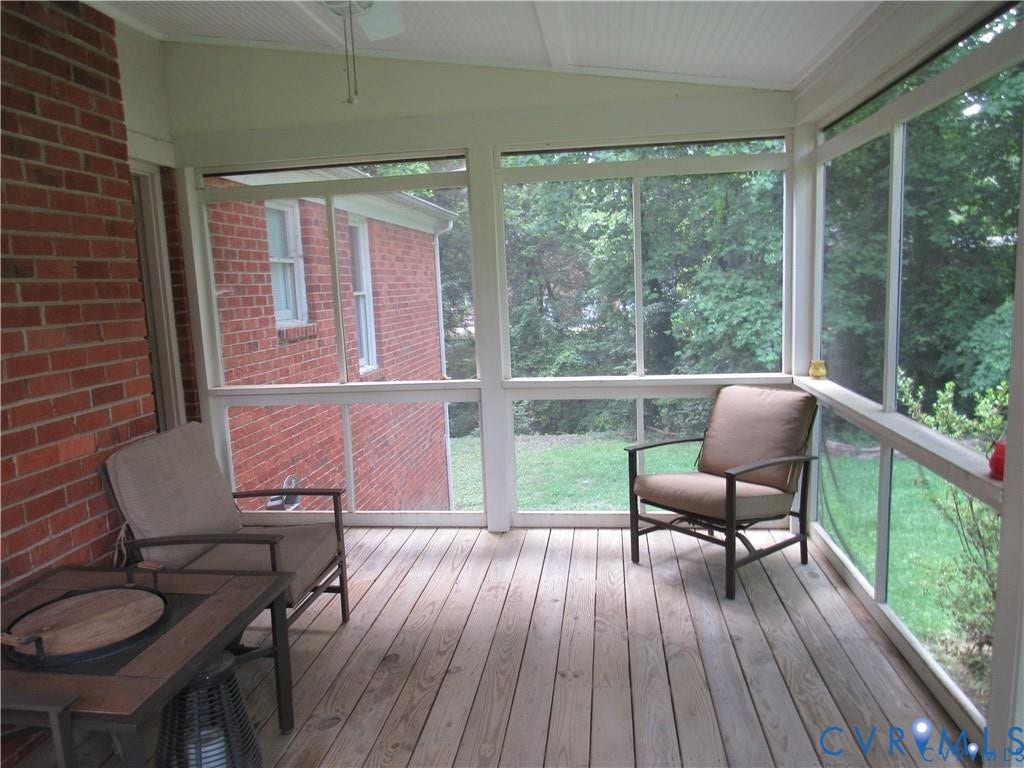8506 Lyndale Drive, Chesterfield, VA 23235 Screened porch with wood-finish flooring, white ceiling fan, and exposed brick wall