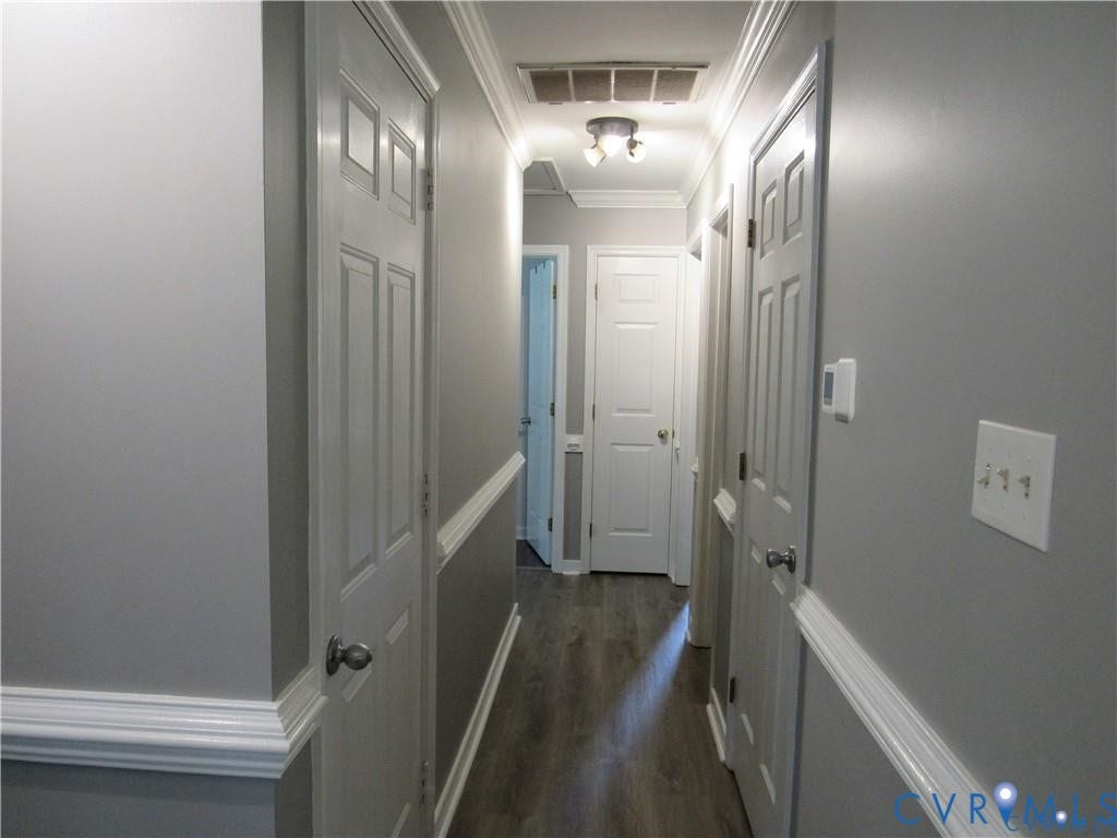 8506 Lyndale Drive, Chesterfield, VA 23235 Hallway with wood-finish flooring, two-tone painted walls, chair rail molding, and crown molding