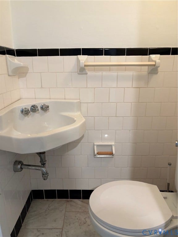 305 N Hamilton Street, #C, Richmond, VA 23221 First level half bath with white subway tile walls with black accent trim