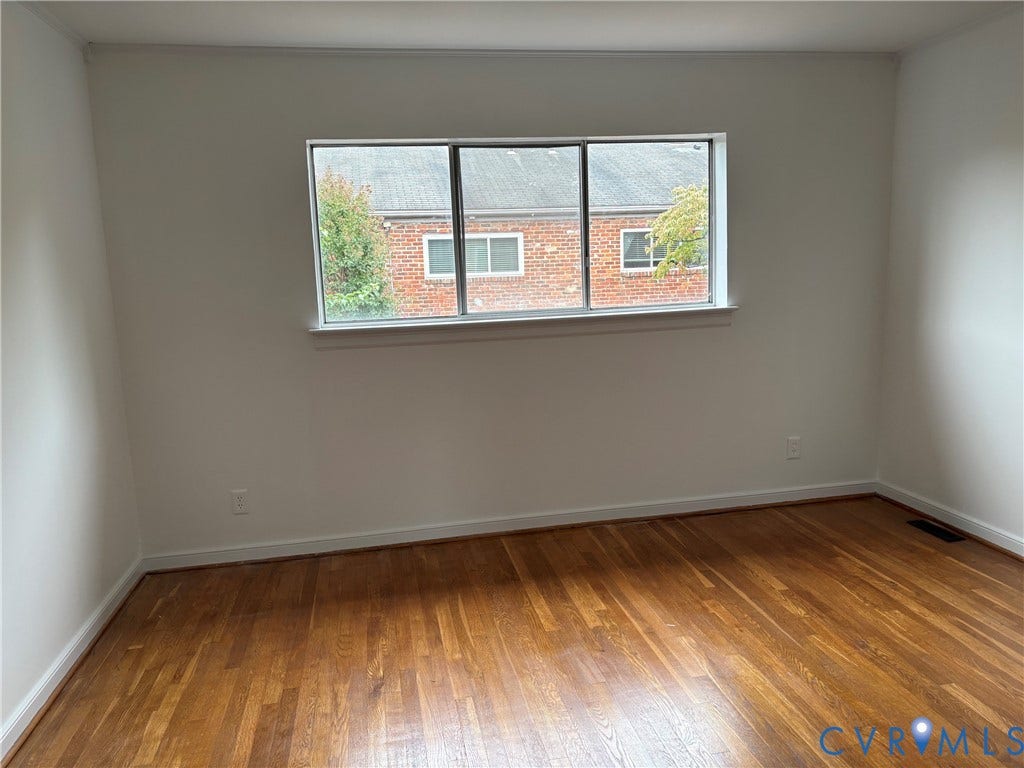 305 N Hamilton Street, #C, Richmond, VA 23221 Hardwood flooring, painted walls, white trim, and a prominent window