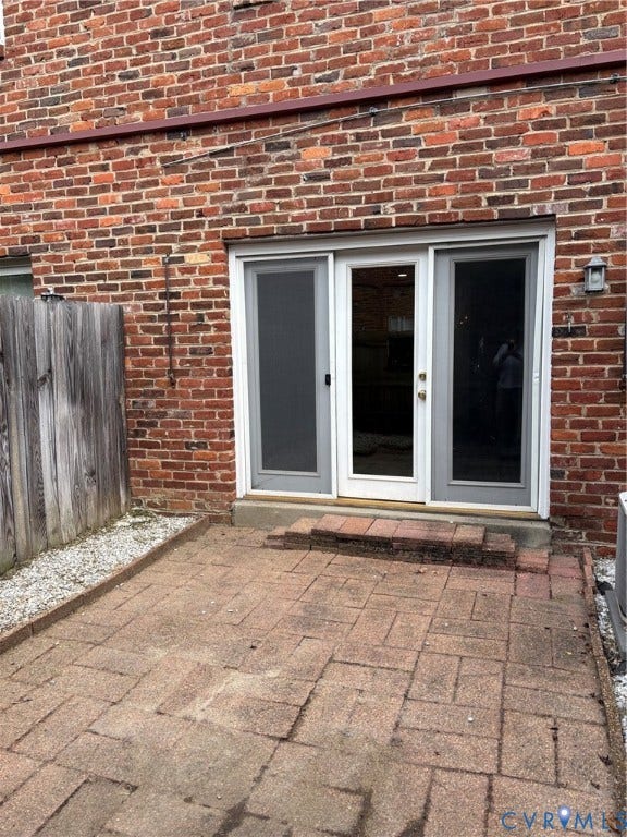 305 N Hamilton Street, #C, Richmond, VA 23221 Brick exterior featuring a patio with paver stones, sliding glass doors, and an exterior light fixture