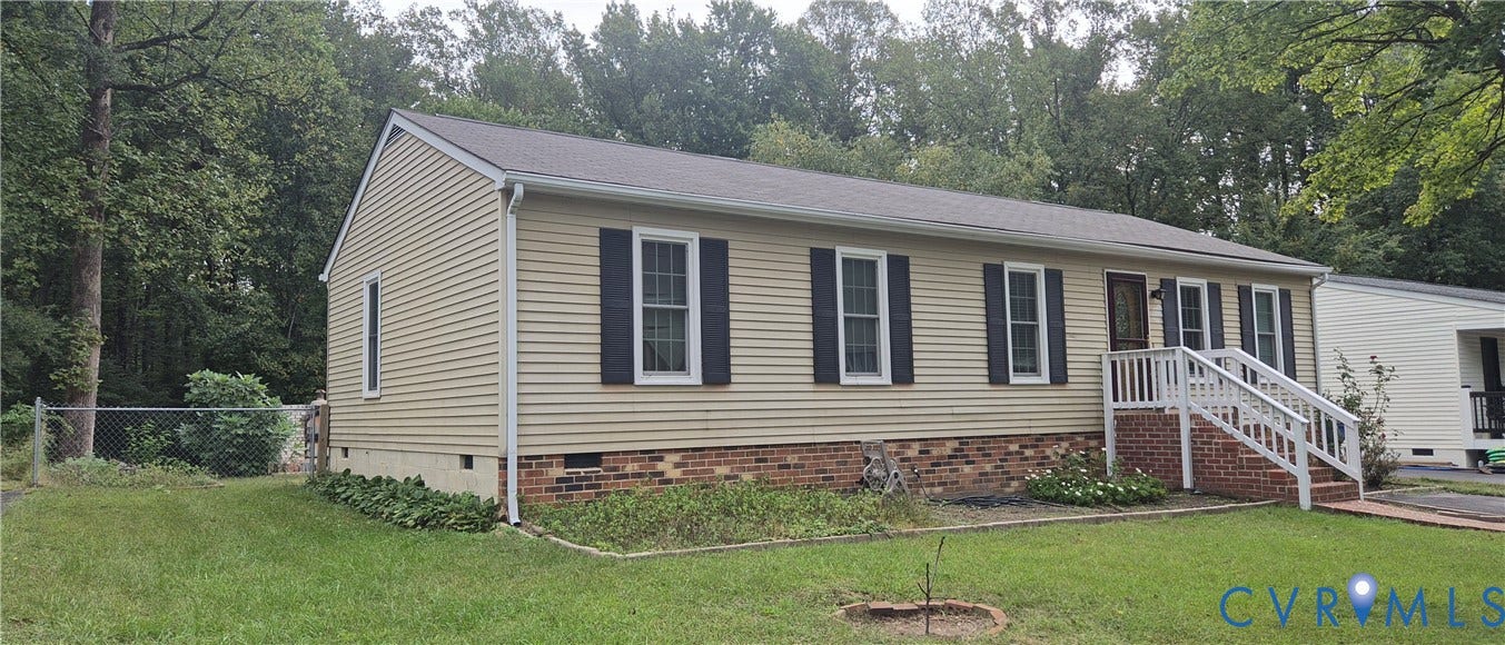 Ranch-style residence featuring horizontal siding, dark shutters, a front porch with white railings, and a partial brick foundation