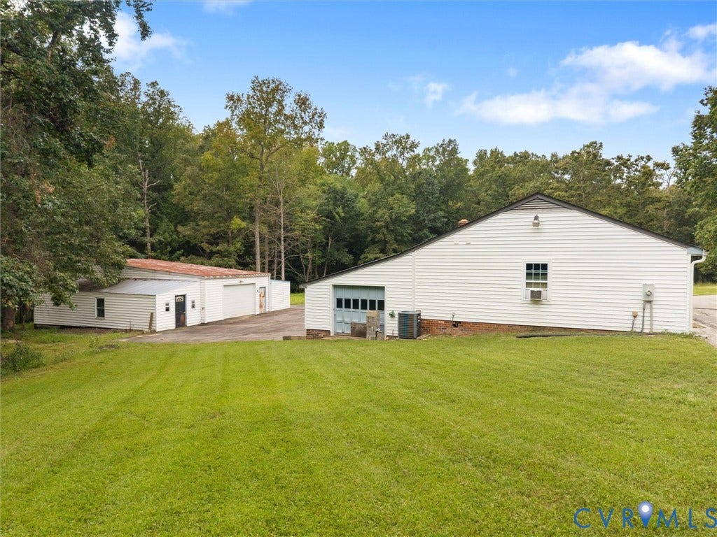 Detached apartment which has three garages, wood stove, window units, laundry, kitchen, huge living area and bed and bath