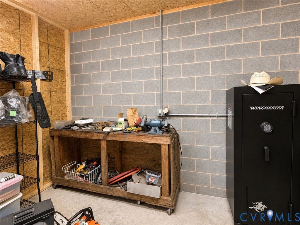 Exposed concrete block wall with a conduit system