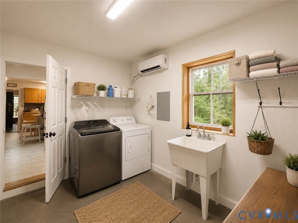Laundry area featuring a utility sink, a window with wood trim, and wall-mounted shelving