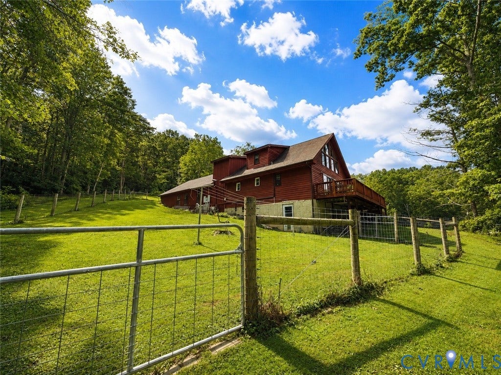 Red siding exterior with a multi-level deck
