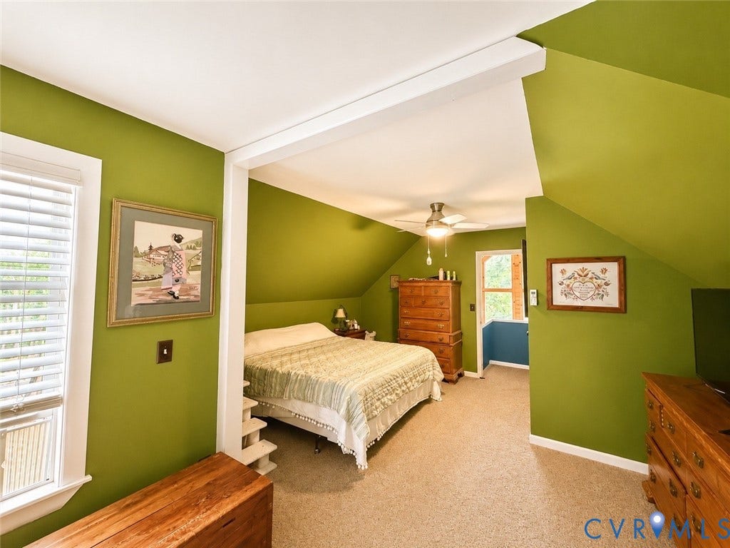Carpeted flooring, vaulted ceiling, white window blinds, and an integrated ceiling fan with lighting