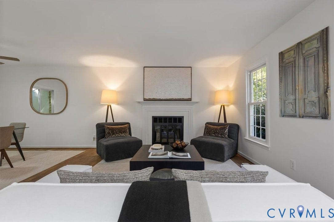 3031 Speeks Drive, Midlothian, VA 23112 Living space featuring a fireplace with a white mantel, wood-finish flooring, and a large window