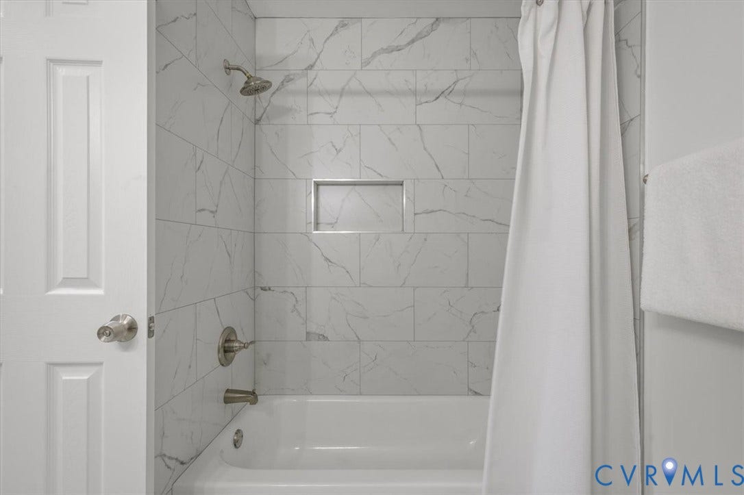 3031 Speeks Drive, Midlothian, VA 23112 White subway tile surround with subtle gray veining, recessed shower niche, and brushed nickel fixtures