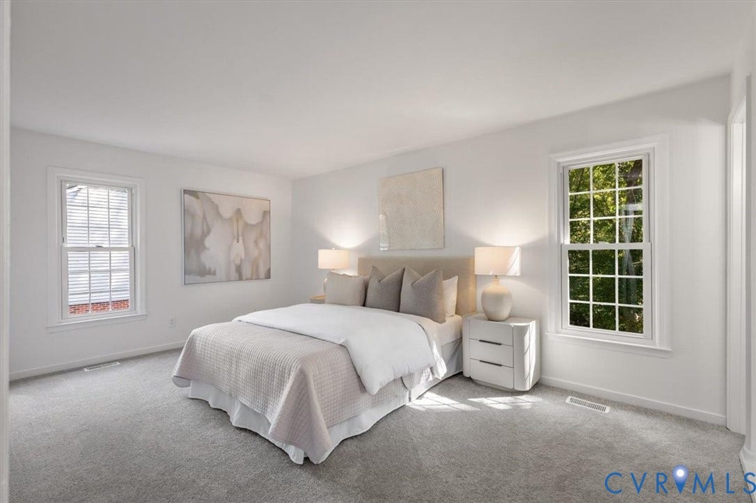 3031 Speeks Drive, Midlothian, VA 23112 Carpeted room with white walls, two windows with white trim, and a built-in closet entrance