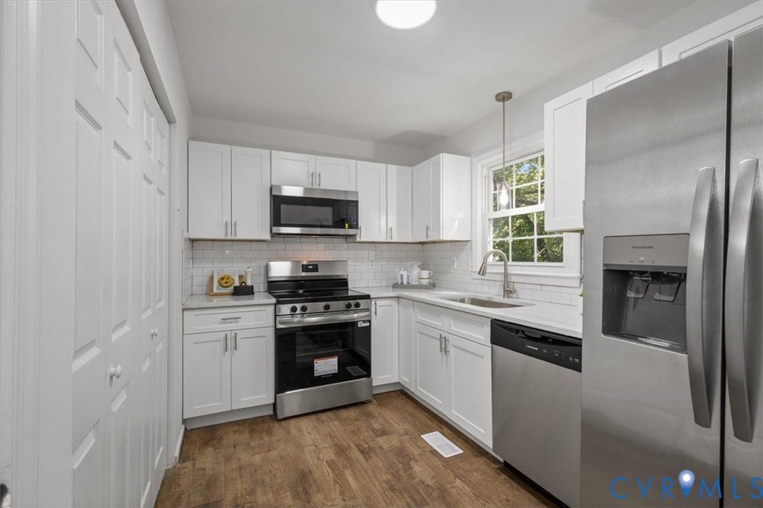 3031 Speeks Drive, Midlothian, VA 23112 Kitchen featuring white cabinetry, stainless steel appliances, white subway tile backsplash, light-toned countertops, and wood-finish flooring
