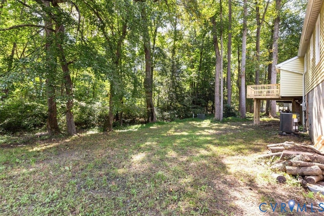 3031 Speeks Drive, Midlothian, VA 23112 Expansive lawn with mature trees and a raised wood-finish deck
