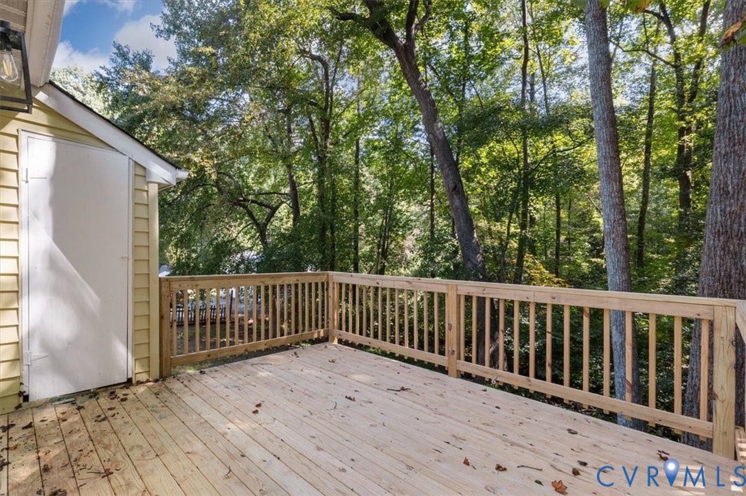 3031 Speeks Drive, Midlothian, VA 23112 Wood deck with a natural finish, wood railing, and surrounding mature trees