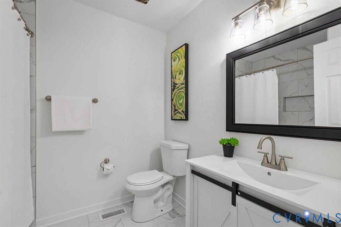 3031 Speeks Drive, Midlothian, VA 23112 White shaker vanity with barn door hardware, rectangular undermount sink, and brushed nickel faucet