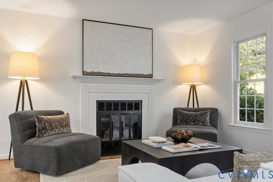 3031 Speeks Drive, Midlothian, VA 23112 Sophisticated living room anchored by a linear fireplace with black surround and glass doors, framed by a white mantel