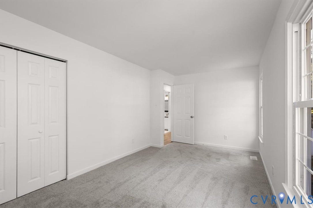 3031 Speeks Drive, Midlothian, VA 23112 White walls with grey carpet flooring, featuring a bifold closet and paneled interior doors